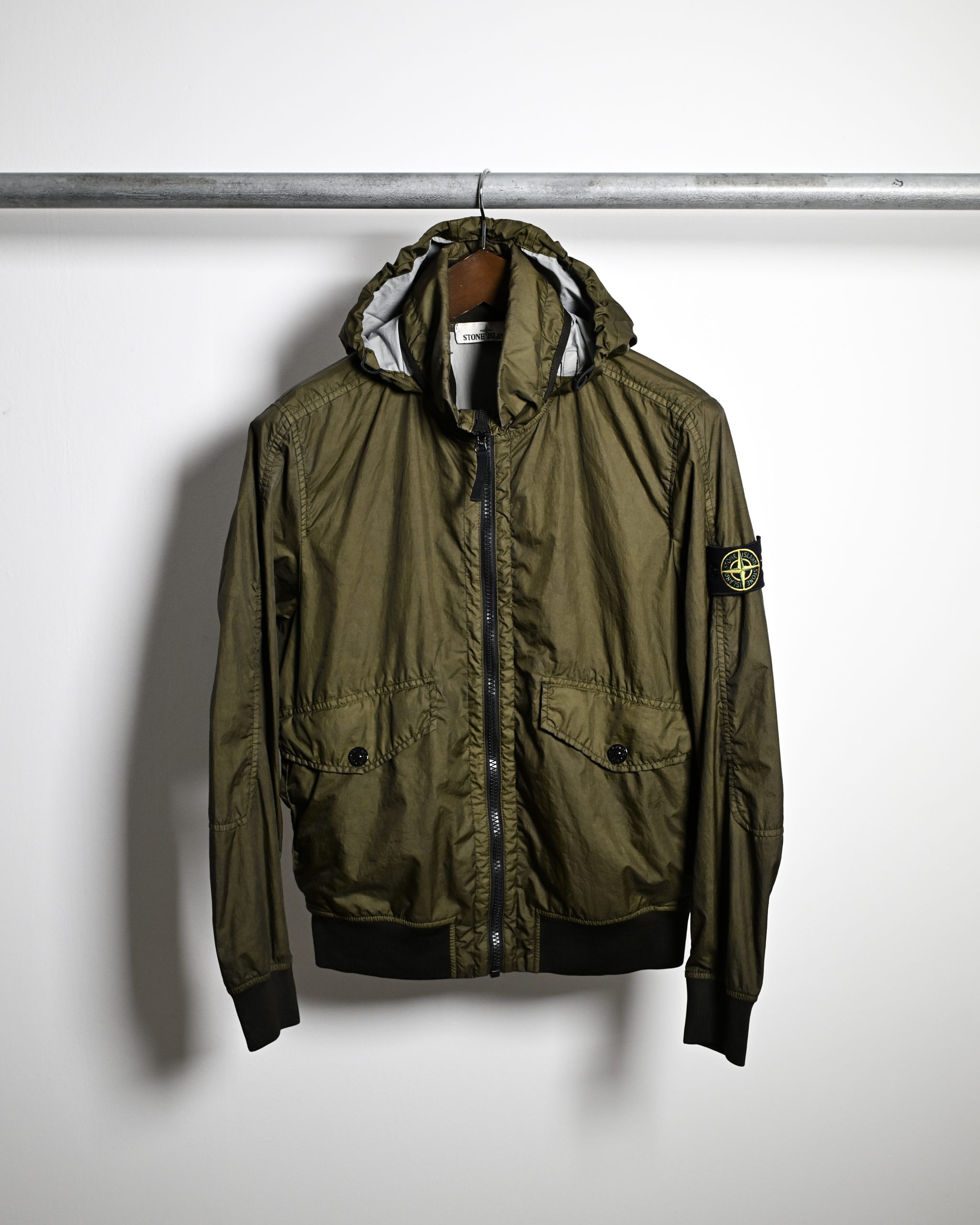 Front side, Stone Island Membrana 3L-TC Jacket, badge on sleeve. Olive Green colour-way.